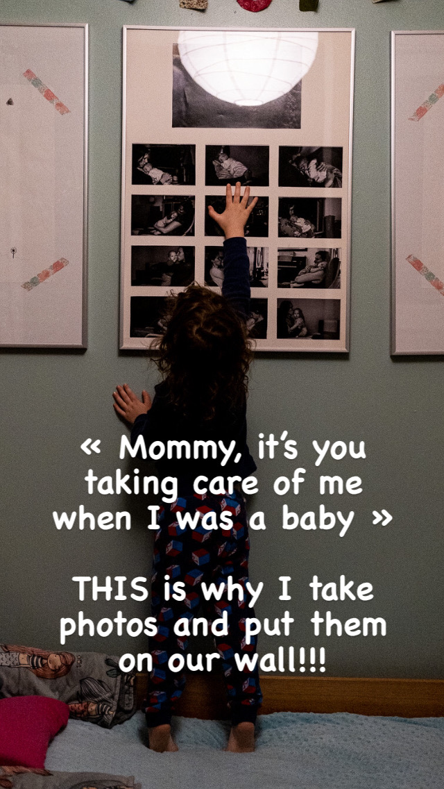 Child poining at photos on a wall with quote